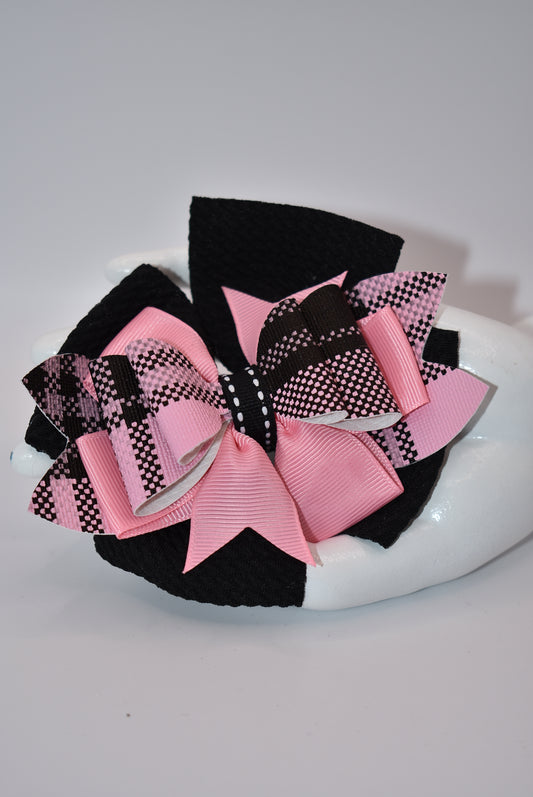 Add a pop of color to your little girl's outfits with Nana's Collection! The beautiful pink and black combination is sure to make her stand out. Plus, the alligator clip makes it easy to wear. This one-of-a-kind bow is perfect for your unique little one!