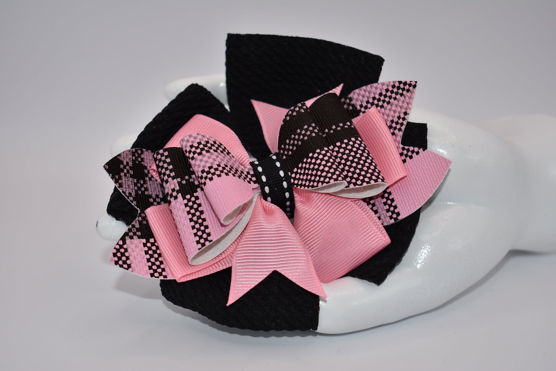 Add a pop of color to your little girl's outfits with Nana's Collection! The beautiful pink and black combination is sure to make her stand out. Plus, the alligator clip makes it easy to wear. This one-of-a-kind bow is perfect for your unique little one!