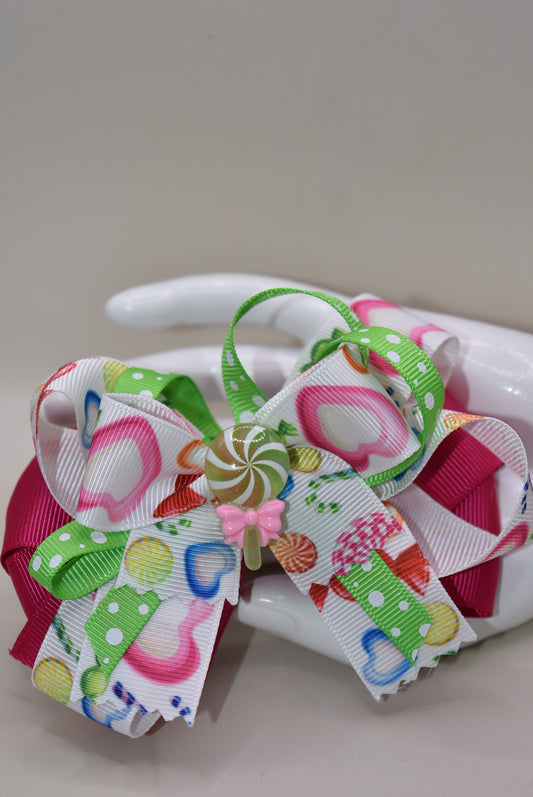 Introducing Nana's Collection 65 - the most fun and playful accessory for your little one! With a candy bow and adorable candy charm, this hair bow will add a touch of sweetness to any outfit. Your little one is sure to fall in love with this cutie and have endless fun wearing it! 🍭
