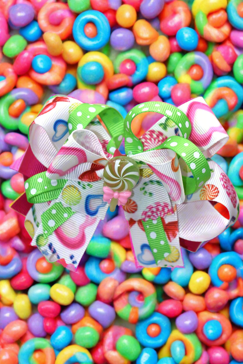 Introducing Nana's Collection 65 - the most fun and playful accessory for your little one! With a candy bow and adorable candy charm, this hair bow will add a touch of sweetness to any outfit. Your little one is sure to fall in love with this cutie and have endless fun wearing it! 🍭