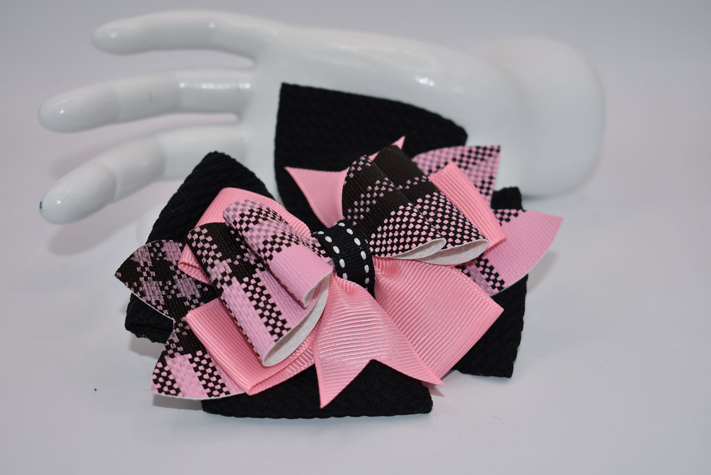 Add a pop of color to your little girl's outfits with Nana's Collection! The beautiful pink and black combination is sure to make her stand out. Plus, the alligator clip makes it easy to wear. This one-of-a-kind bow is perfect for your unique little one!