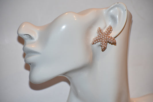 "Sail away with our Nautical Collection! These earrings feature a fun and delicate tiny pearl starfish design, perfect for adding a touch of whimsy to any outfit. Made with hypoallergenic materials, they're safe and comfortable for sensitive ears. With gold filled posts, they're the ideal accessory for any sundress or nautical outfit. Let your style set sail!"