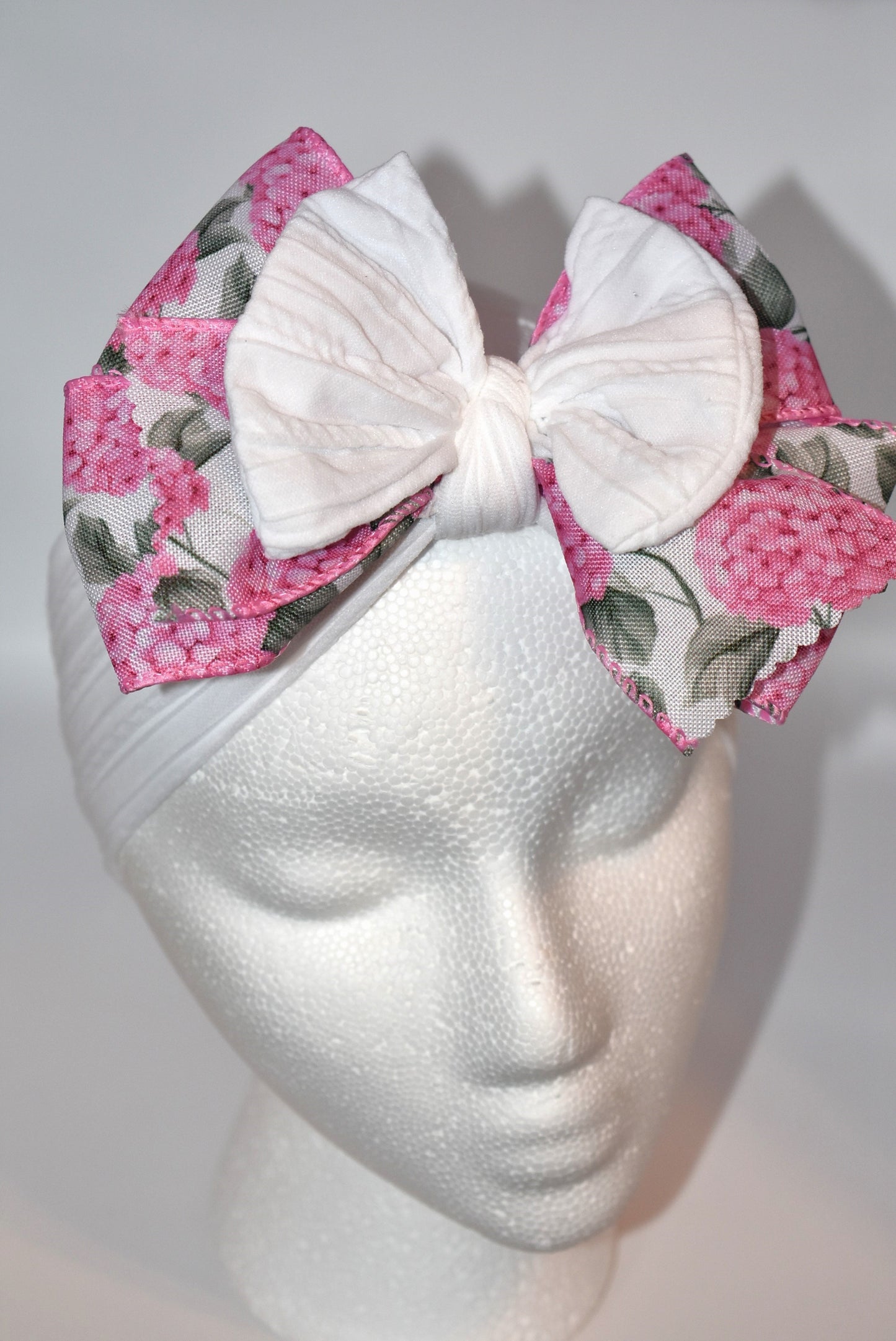 Add a pop of charm with this Wrapped Headband Collection 3! 🌸 Featuring a playful bow on top and a stunning pink flower ribbon beneath, it's the perfect accessory to catch those admiring glances. Comfortable and unique, this wide headband is your go-to for effortless style and a little touch of fun! 🎀✨
