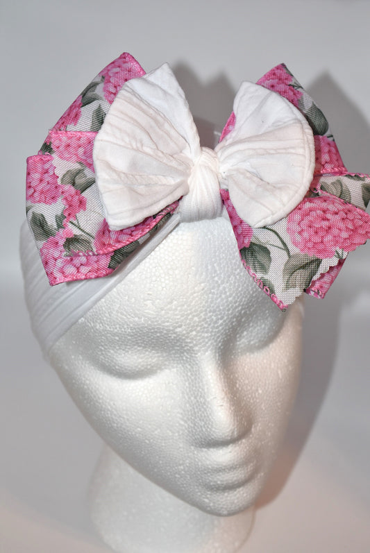 Add a pop of charm with this Wrapped Headband Collection 3! 🌸 Featuring a playful bow on top and a stunning pink flower ribbon beneath, it's the perfect accessory to catch those admiring glances. Comfortable and unique, this wide headband is your go-to for effortless style and a little touch of fun! 🎀✨