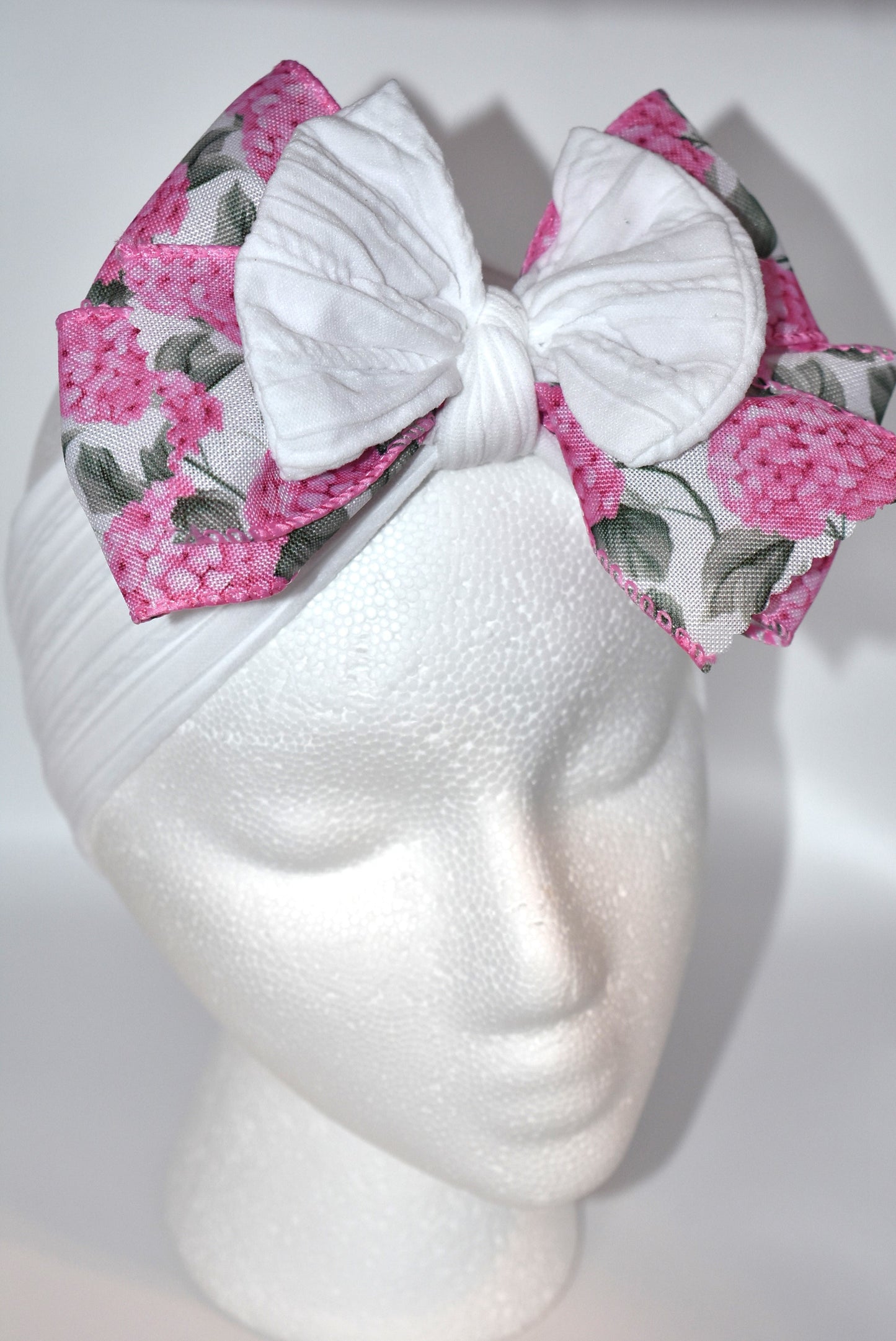 Add a pop of charm with this Wrapped Headband Collection 3! 🌸 Featuring a playful bow on top and a stunning pink flower ribbon beneath, it's the perfect accessory to catch those admiring glances. Comfortable and unique, this wide headband is your go-to for effortless style and a little touch of fun! 🎀✨