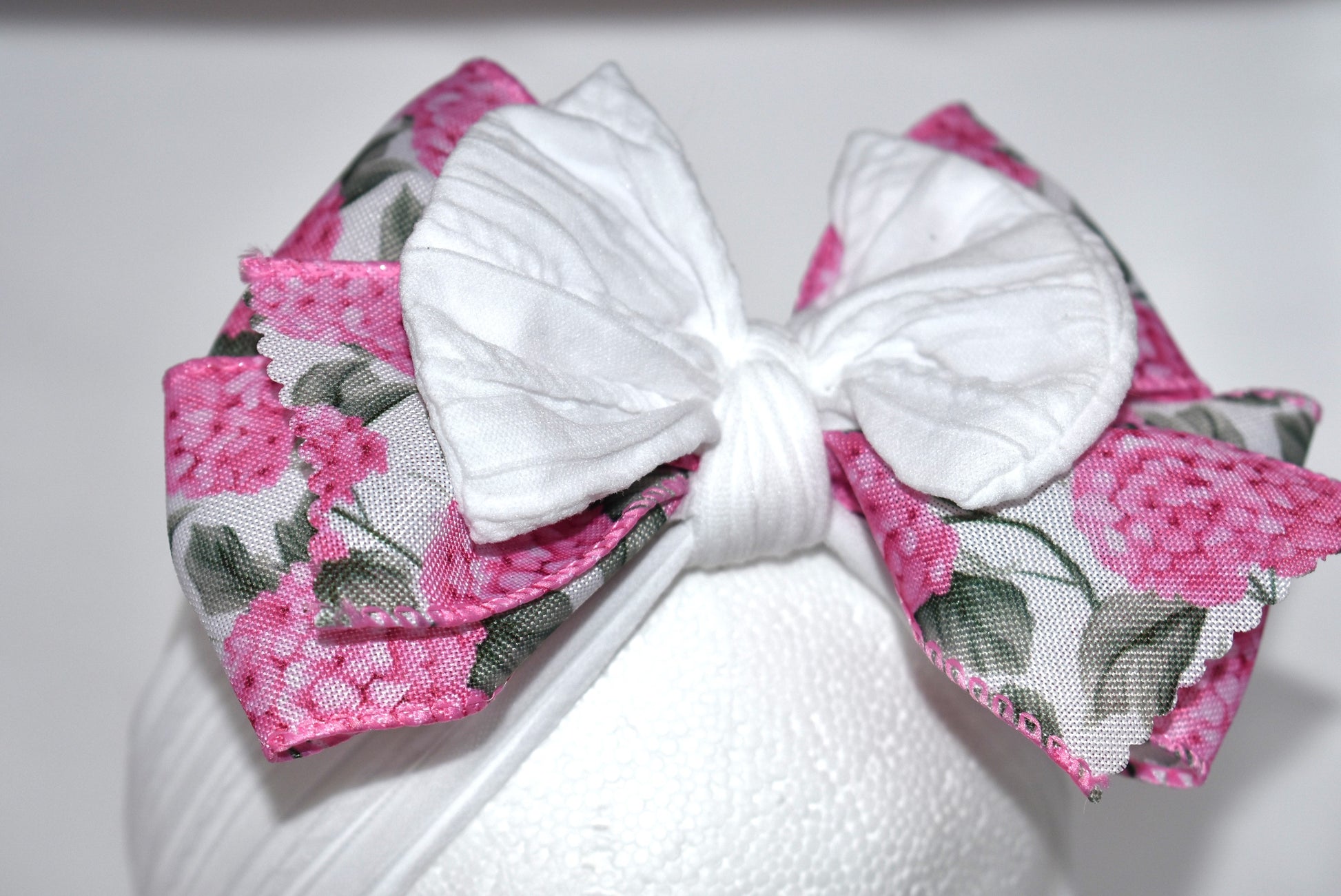 Add a pop of charm with this Wrapped Headband Collection 3! 🌸 Featuring a playful bow on top and a stunning pink flower ribbon beneath, it's the perfect accessory to catch those admiring glances. Comfortable and unique, this wide headband is your go-to for effortless style and a little touch of fun! 🎀✨
