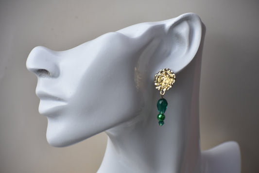 The Green Collection 16 is an exquisite one-of-a-kind piece, perfect for making a statement. It features beautiful rose looking gold posts, with emerald green crystals and pearls to create a stunning, eye-catching combination. The perfect size for comfort and elegance.