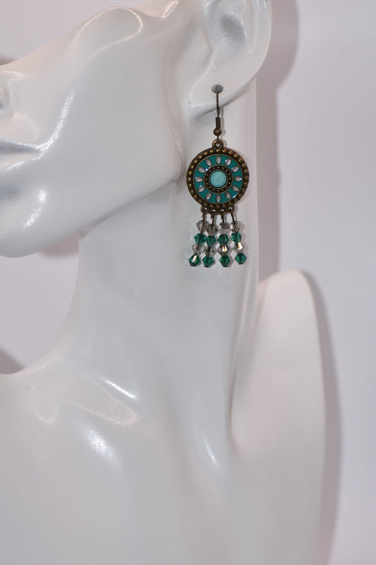 Unleash your wild side with our Western Collection earrings! These charming green crystals hang at just the right length from hypoallergenic brown hooks. No need to sacrifice style for comfort with this 2-inch dangle.