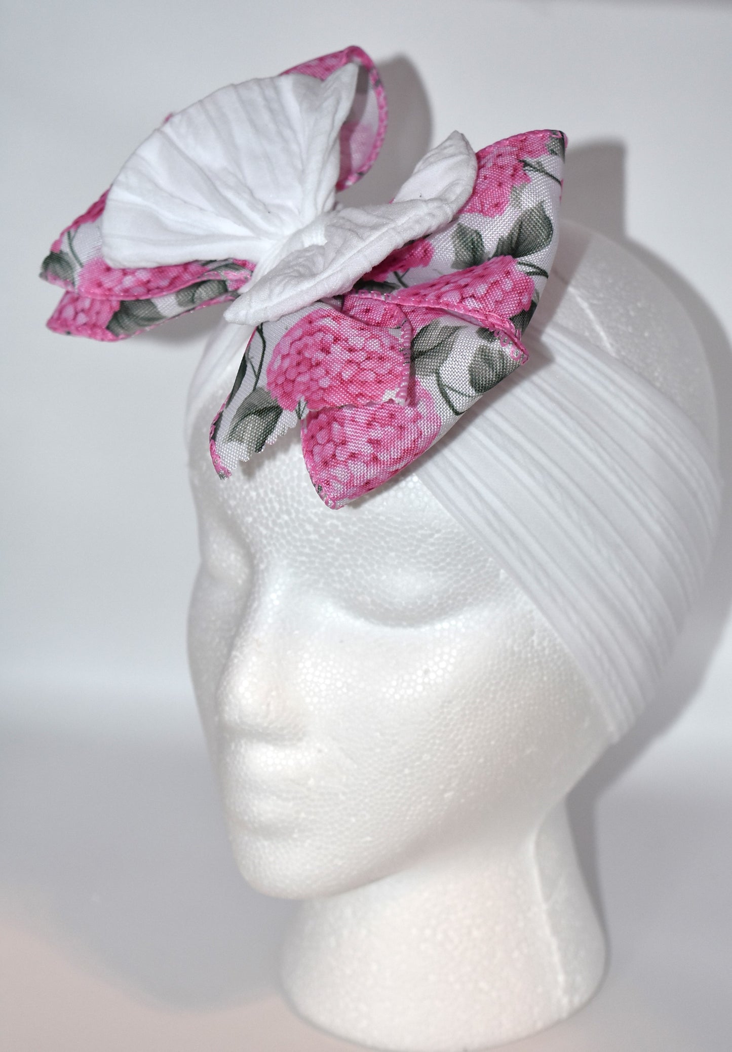 Add a pop of charm with this Wrapped Headband Collection 3! 🌸 Featuring a playful bow on top and a stunning pink flower ribbon beneath, it's the perfect accessory to catch those admiring glances. Comfortable and unique, this wide headband is your go-to for effortless style and a little touch of fun! 🎀✨