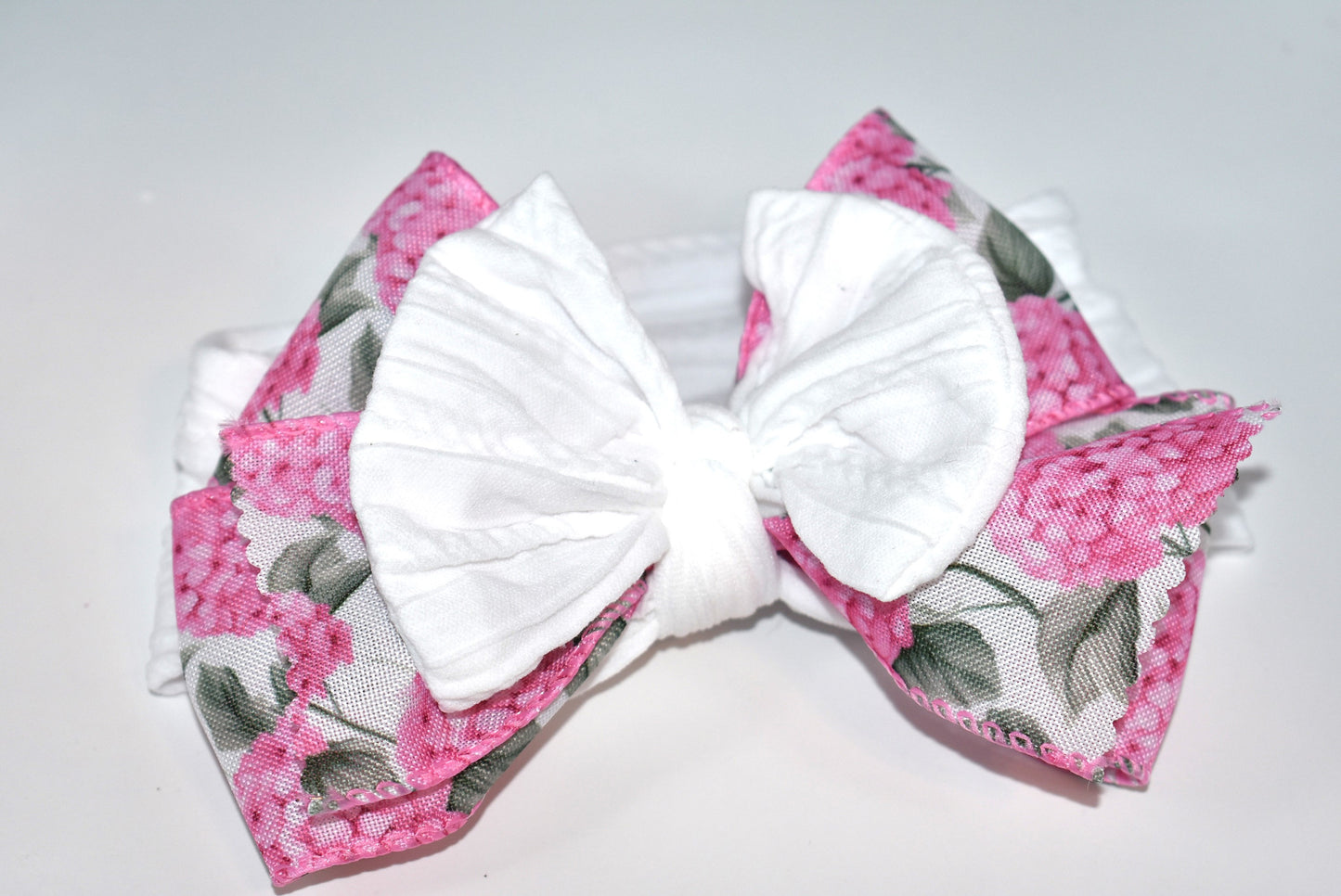 Add a pop of charm with this Wrapped Headband Collection 3! 🌸 Featuring a playful bow on top and a stunning pink flower ribbon beneath, it's the perfect accessory to catch those admiring glances. Comfortable and unique, this wide headband is your go-to for effortless style and a little touch of fun! 🎀✨