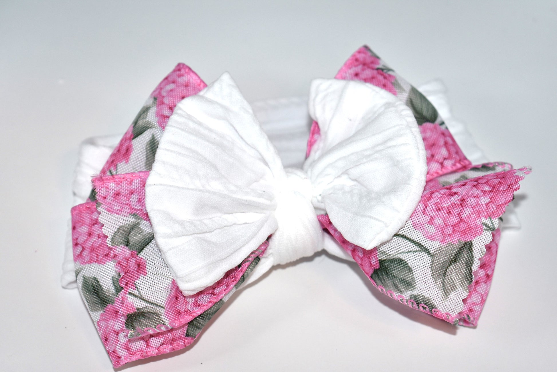 Add a pop of charm with this Wrapped Headband Collection 3! 🌸 Featuring a playful bow on top and a stunning pink flower ribbon beneath, it's the perfect accessory to catch those admiring glances. Comfortable and unique, this wide headband is your go-to for effortless style and a little touch of fun! 🎀✨