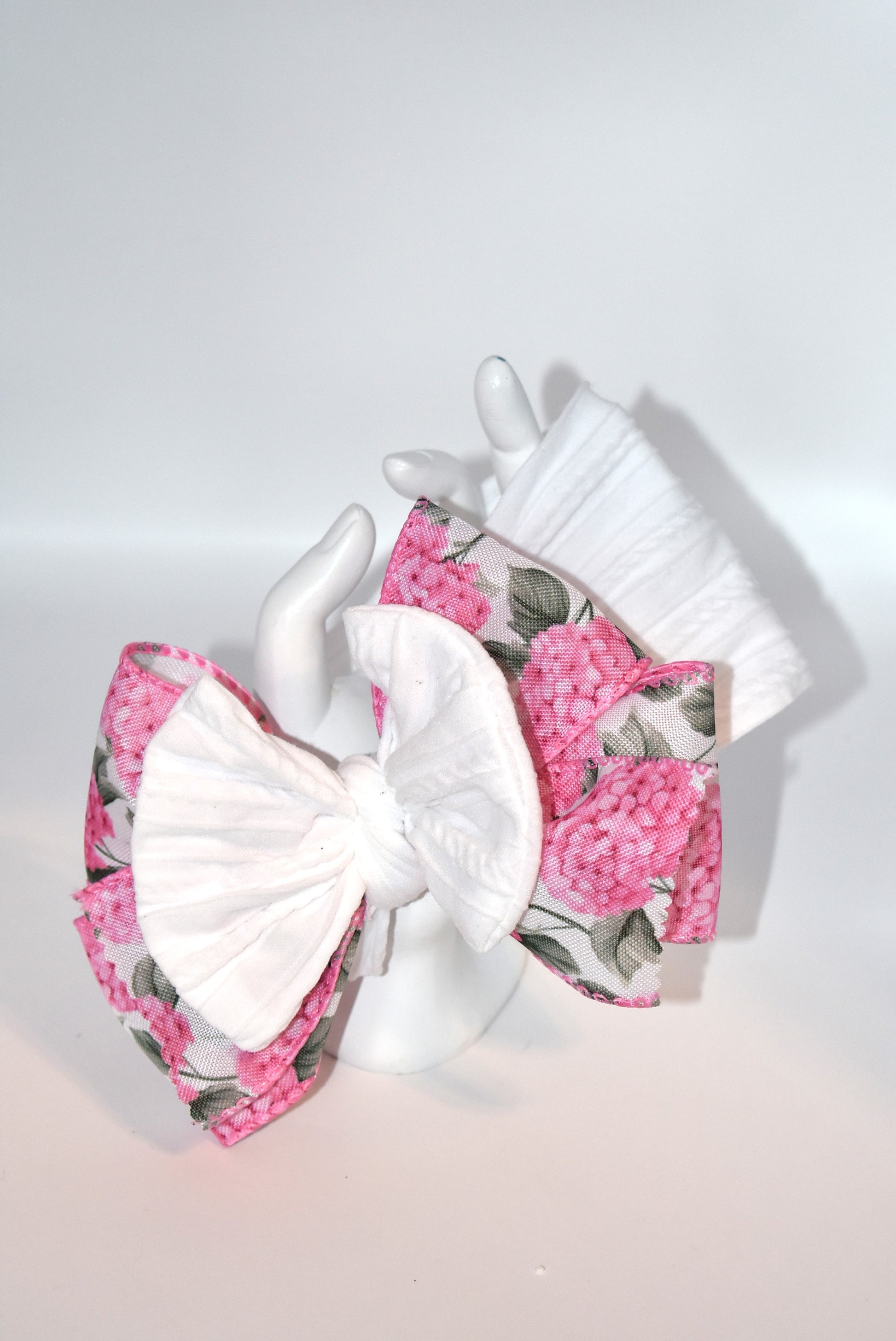 Add a pop of charm with this Wrapped Headband Collection 3! 🌸 Featuring a playful bow on top and a stunning pink flower ribbon beneath, it's the perfect accessory to catch those admiring glances. Comfortable and unique, this wide headband is your go-to for effortless style and a little touch of fun! 🎀✨