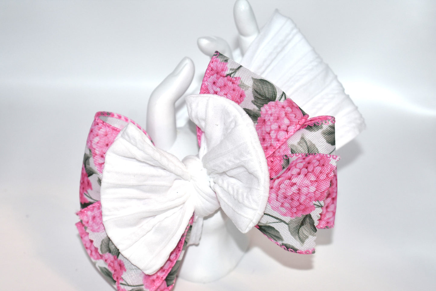 Add a pop of charm with this Wrapped Headband Collection 3! 🌸 Featuring a playful bow on top and a stunning pink flower ribbon beneath, it's the perfect accessory to catch those admiring glances. Comfortable and unique, this wide headband is your go-to for effortless style and a little touch of fun! 🎀✨