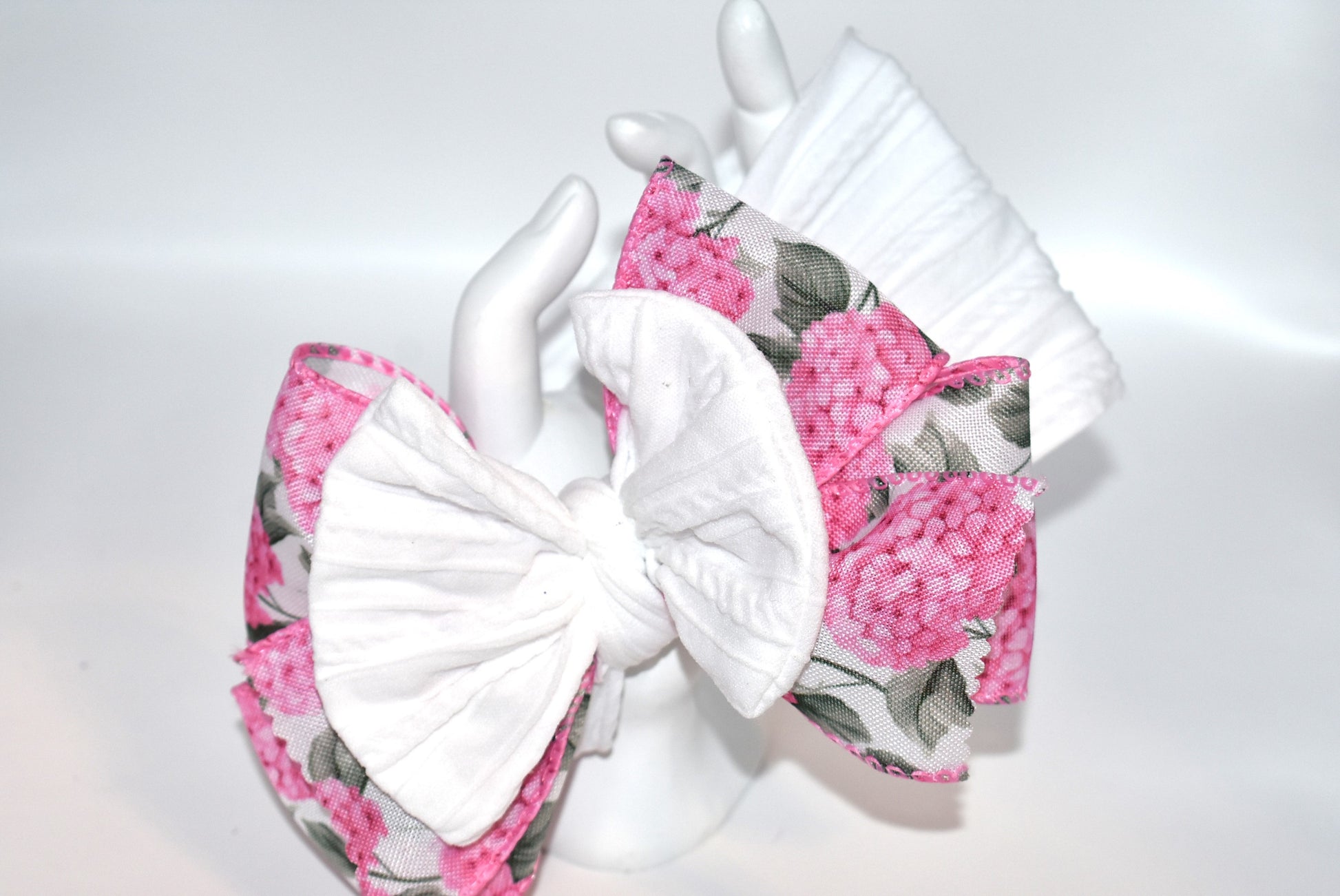 Add a pop of charm with this Wrapped Headband Collection 3! 🌸 Featuring a playful bow on top and a stunning pink flower ribbon beneath, it's the perfect accessory to catch those admiring glances. Comfortable and unique, this wide headband is your go-to for effortless style and a little touch of fun! 🎀✨