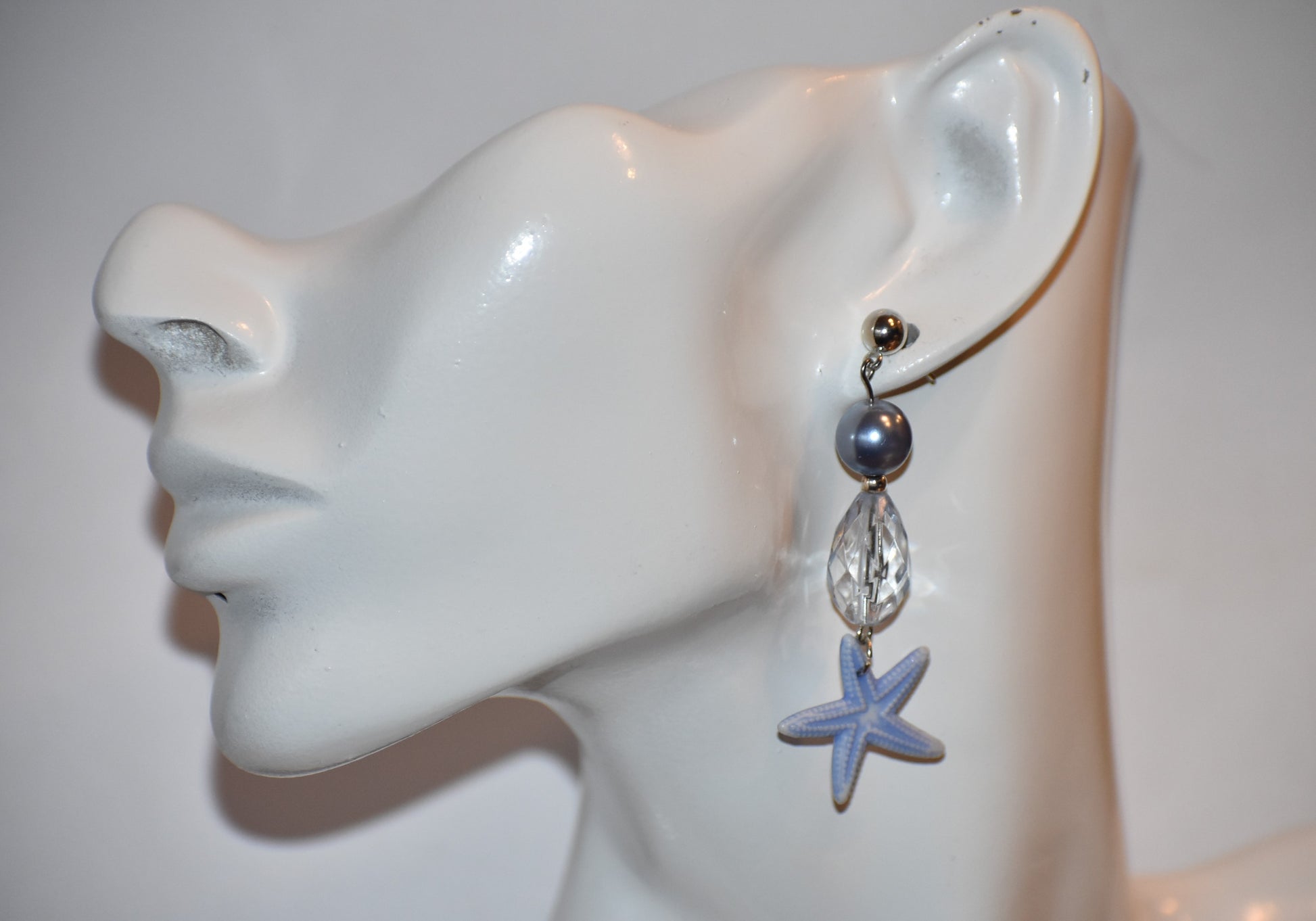 ⚓️ Add a touch of nautical elegance to your wardrobe with our Nautical Collection! These stunning blue pearl, crystal and starfish earrings are held securely by silver hypoallergenic posts. Lightweight and comfortable, they hang 2" off the ear. Perfect for any occasion!