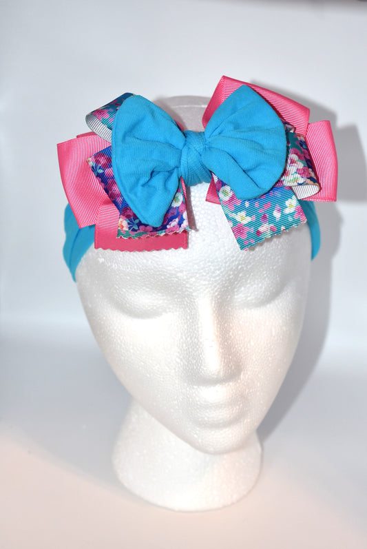 Add a splash of fun to your look with this Wrapped Headband from our Collection 4! 🎀 Featuring soft pink and blue hues and a charming flower motif 🌸, it’s perfect for anyone who loves a cheerful pop of color. One-of-a-kind and delightfully playful, this headband brightens any outfit with a touch of whimsy! ✨