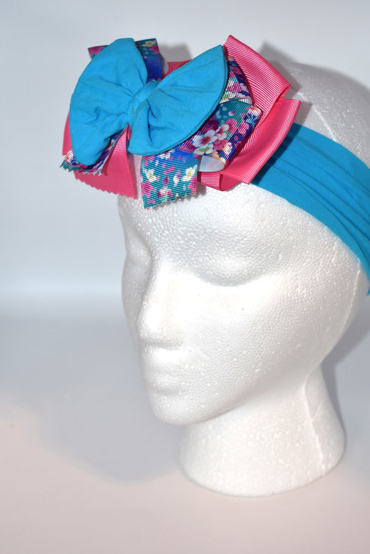 Add a splash of fun to your look with this Wrapped Headband from our Collection 4! 🎀 Featuring soft pink and blue hues and a charming flower motif 🌸, it’s perfect for anyone who loves a cheerful pop of color. One-of-a-kind and delightfully playful, this headband brightens any outfit with a touch of whimsy! ✨
