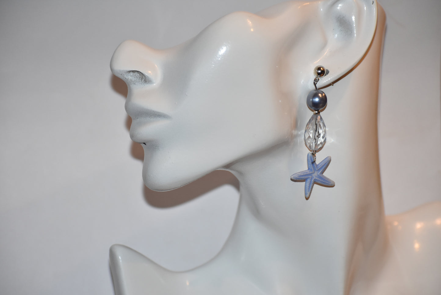 ⚓️ Add a touch of nautical elegance to your wardrobe with our Nautical Collection! These stunning blue pearl, crystal and starfish earrings are held securely by silver hypoallergenic posts. Lightweight and comfortable, they hang 2" off the ear. Perfect for any occasion!