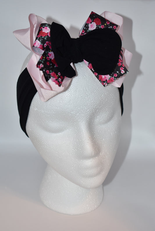 Add a splash of charm with this soft black and pink nylon headband featuring a lovely flower motif ribbon at the center 🌸. Its layered design brings extra beauty and fun, perfect for all ages! A unique, one-of-a-kind accessory to brighten up any outfit 🎀✨.