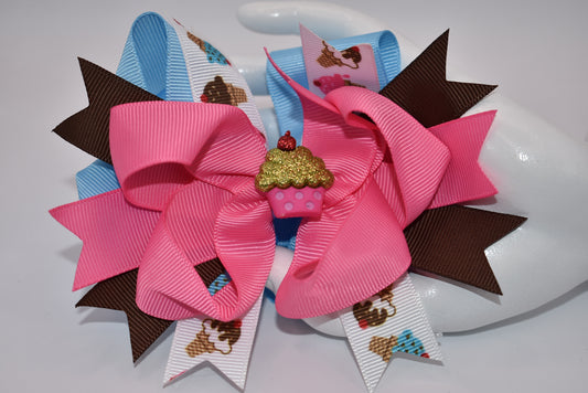 Add some flavor to your little one's style with Nana's Collection! This layered ice cream bow comes in a playful mix of brown, blue, and pink to complement any outfit. The alligator clip makes for easy on and off hair application. It's the perfect blend of fun and function.