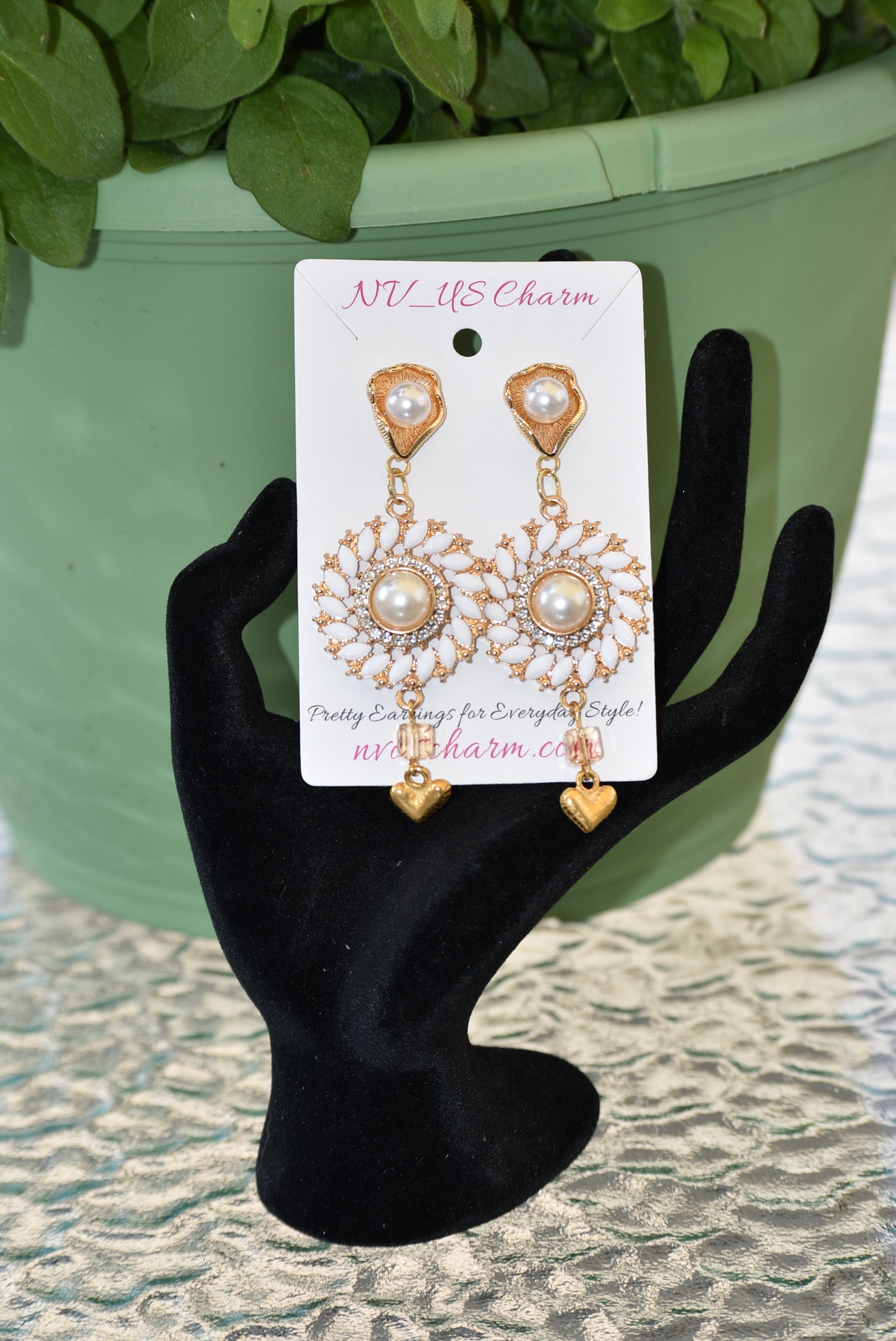 Our Wedding Collection 18 earrings feature bold gold colors and an unusual pearl post, bordered with white marquise beading and white crystals. A small gold heart hangs from the bottom, making a huge statement on the ear. Perfect for any special occasion.