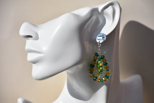 Emerald Green and Gold crystal beads shaped in a teardrop with a pretty green egg shaped bead in the middle add a little extra something to these earrings on the ear.  They hang from silver posts and are definitely an eye catcher.  