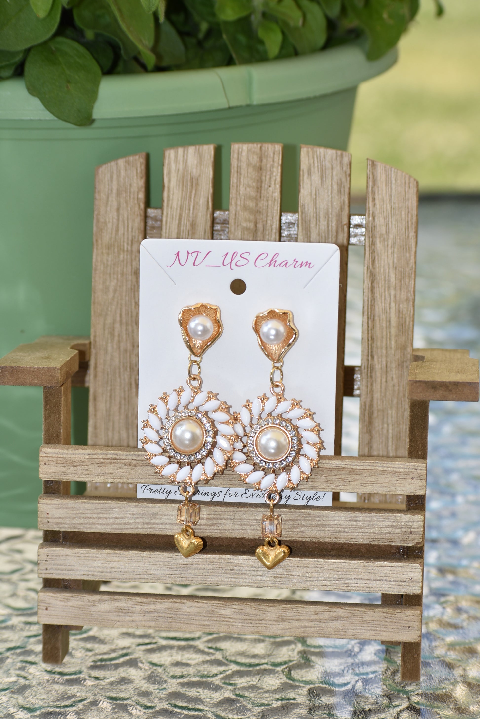 Our Wedding Collection 18 earrings feature bold gold colors and an unusual pearl post, bordered with white marquise beading and white crystals. A small gold heart hangs from the bottom, making a huge statement on the ear. Perfect for any special occasion.