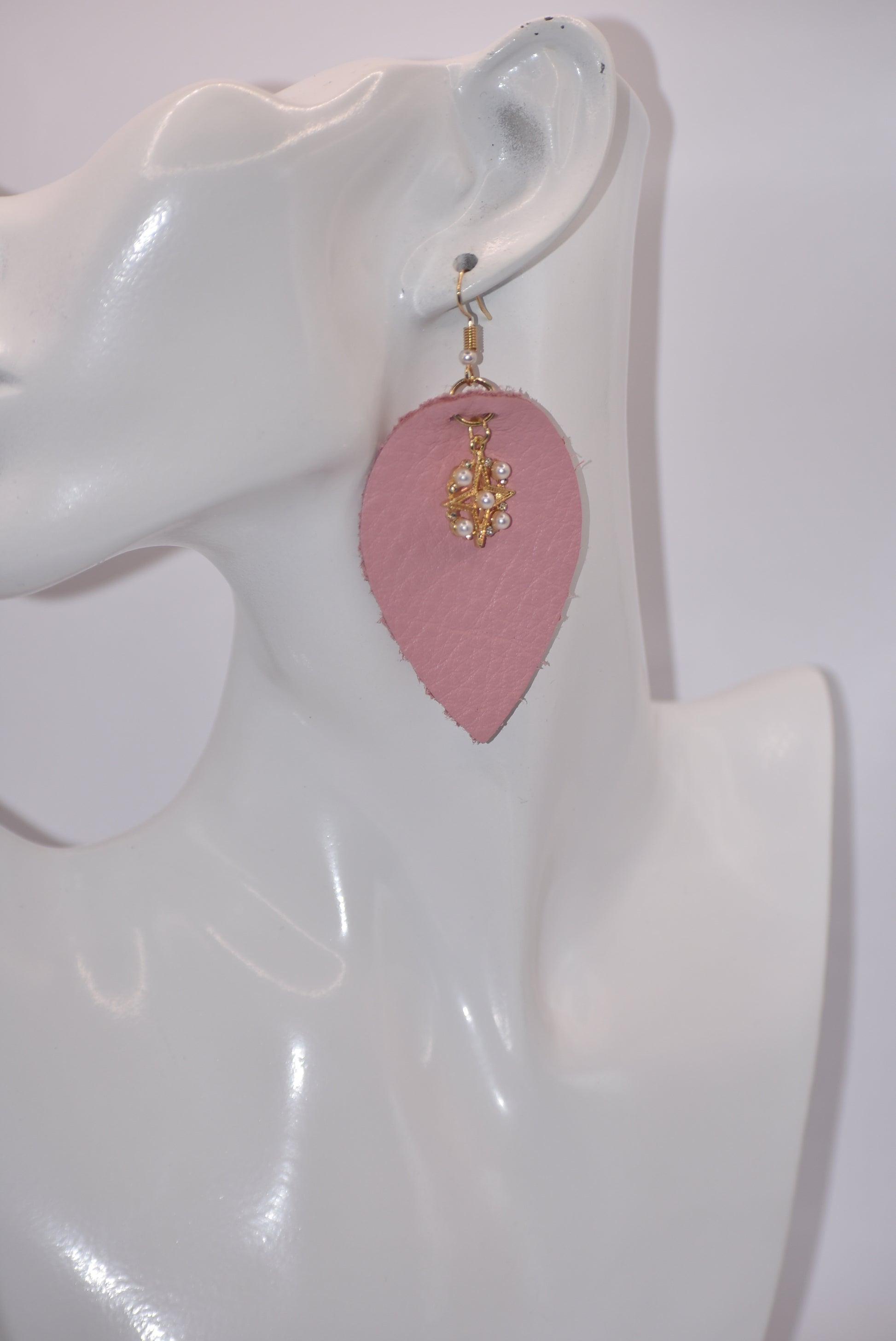 Make a statement with our Pink Collection! These adorable earrings feature pink soft faux leather teardrops and a pretty pearl charm, perfect for adding a touch of sweetness to any outfit. The hypoallergenic gold filled hooks make them suitable for even the most sensitive ears.