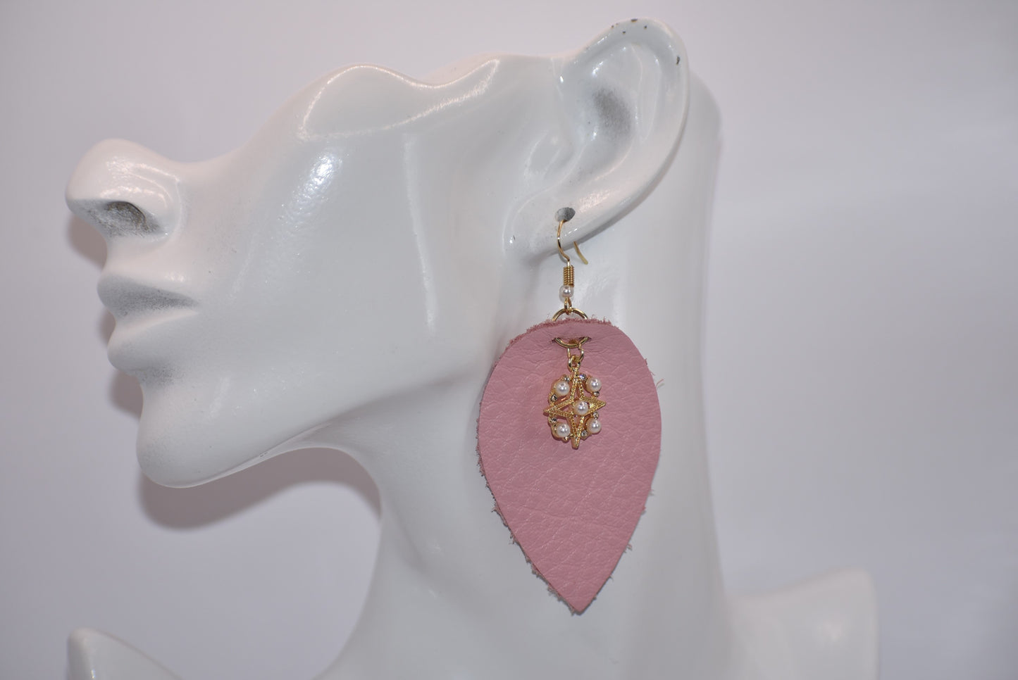 Make a statement with our Pink Collection! These adorable earrings feature pink soft faux leather teardrops and a pretty pearl charm, perfect for adding a touch of sweetness to any outfit. The hypoallergenic gold filled hooks make them suitable for even the most sensitive ears.