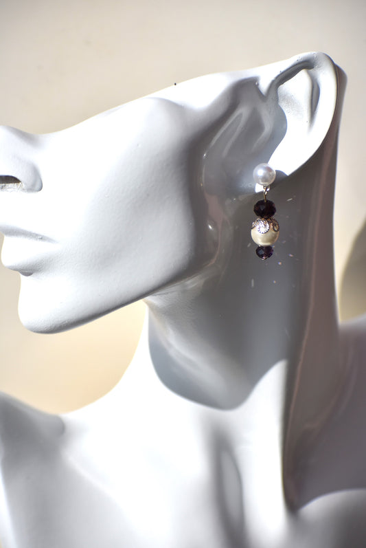 The Purple Collection 12 is a beautiful addition to any wardrobe. The pearl posts and purple crystals provide a gorgeous contrast that is perfect for any occasion. These earrings are sure to make a statement.