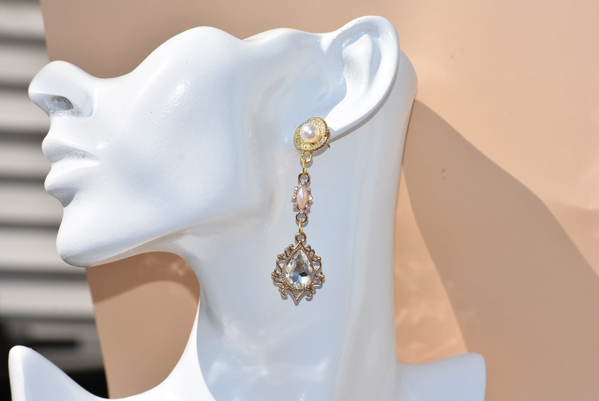 Make a lasting impression on your big day with our Wedding Collection 12 earrings! Handcrafted with hypoallergenic pearl posts and a dazzling cubic zirconia diamond pendant hanging from a beautiful pearl connector, this one-of-a-kind piece is the perfect accessory for any bride.