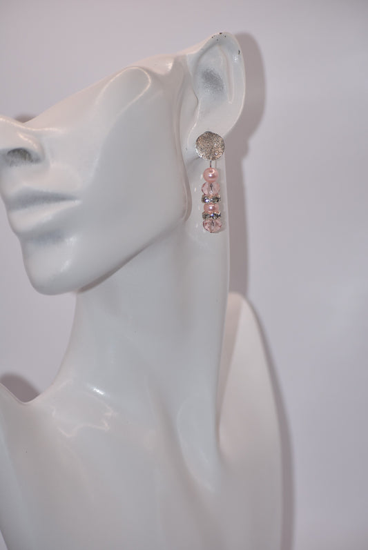 "Sparkle in style with our Pink Collection! These earrings feature a pretty silver crushed sparkle post, adorned with a stunning combination of pink pearls and white/pink crystals. Perfect for any occasion, these earrings are sure to add a touch of playfulness to your look. Get ready to be pretty in pink!"