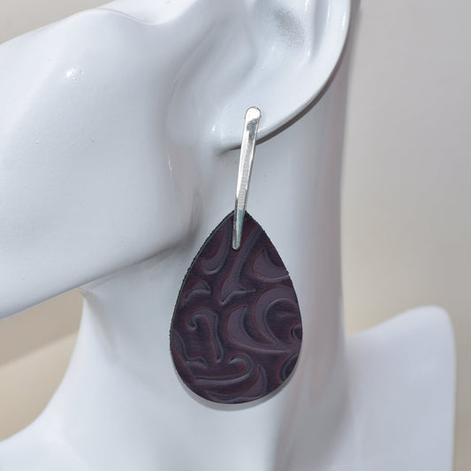 "Indulge in the perfect mix of style and comfort with our Purple Collection 2 earrings. Made with hypoallergenic silver posts, these stunning teardrop earrings feature a unique damask faux leather design. Perfect for adding a touch of sexy and sass to any outfit!"