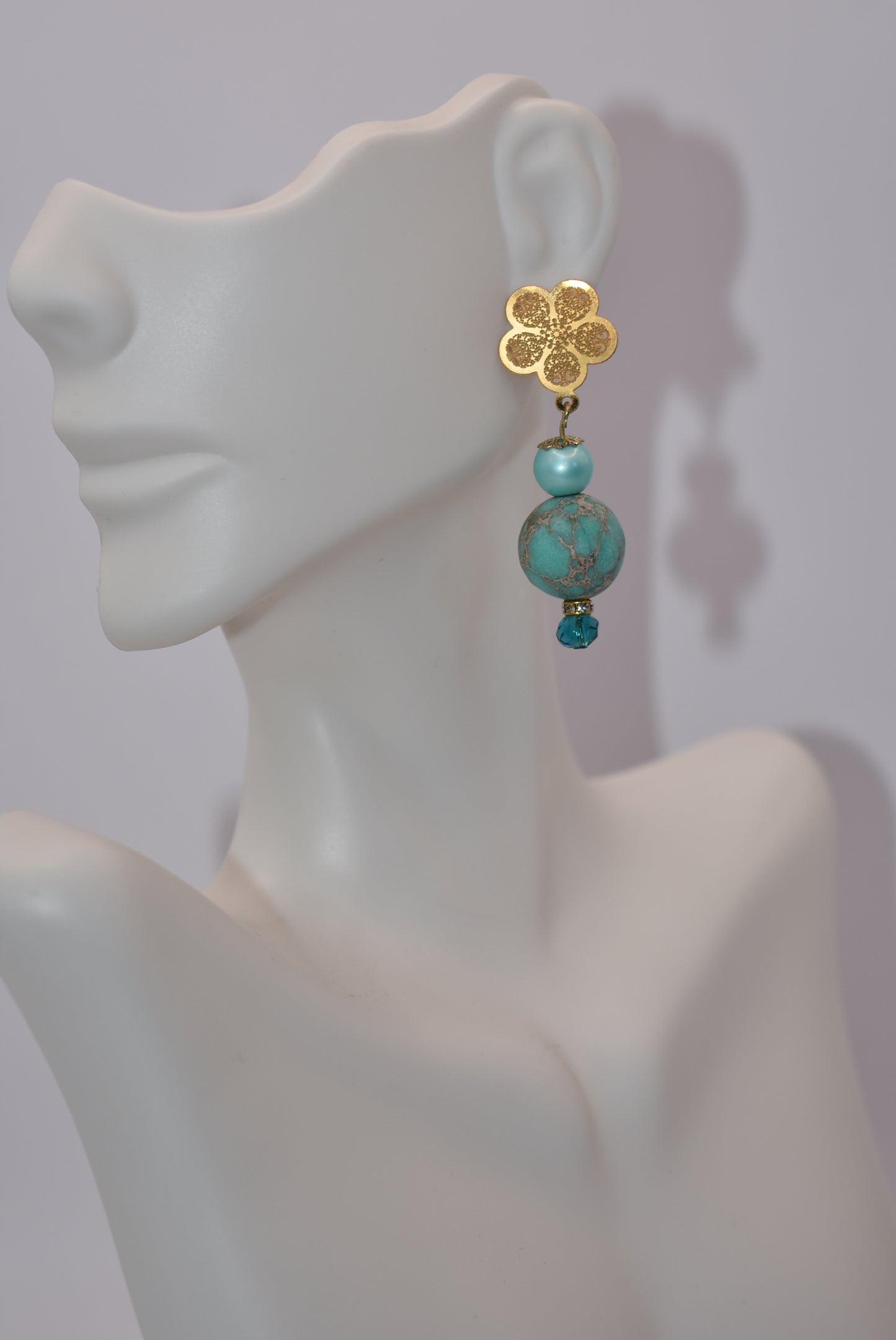 Get ready for adventure? These earrings are ready to go with you.&nbsp; Gold flowered hanging post earrings with aqua pearls, pretty beads and diamond crystal accents bring these beauties together. Nickel free and hypoallergenic for sensitive ears.&nbsp; Super comfortable on the ear.&nbsp; One-of-a-kind-piece.