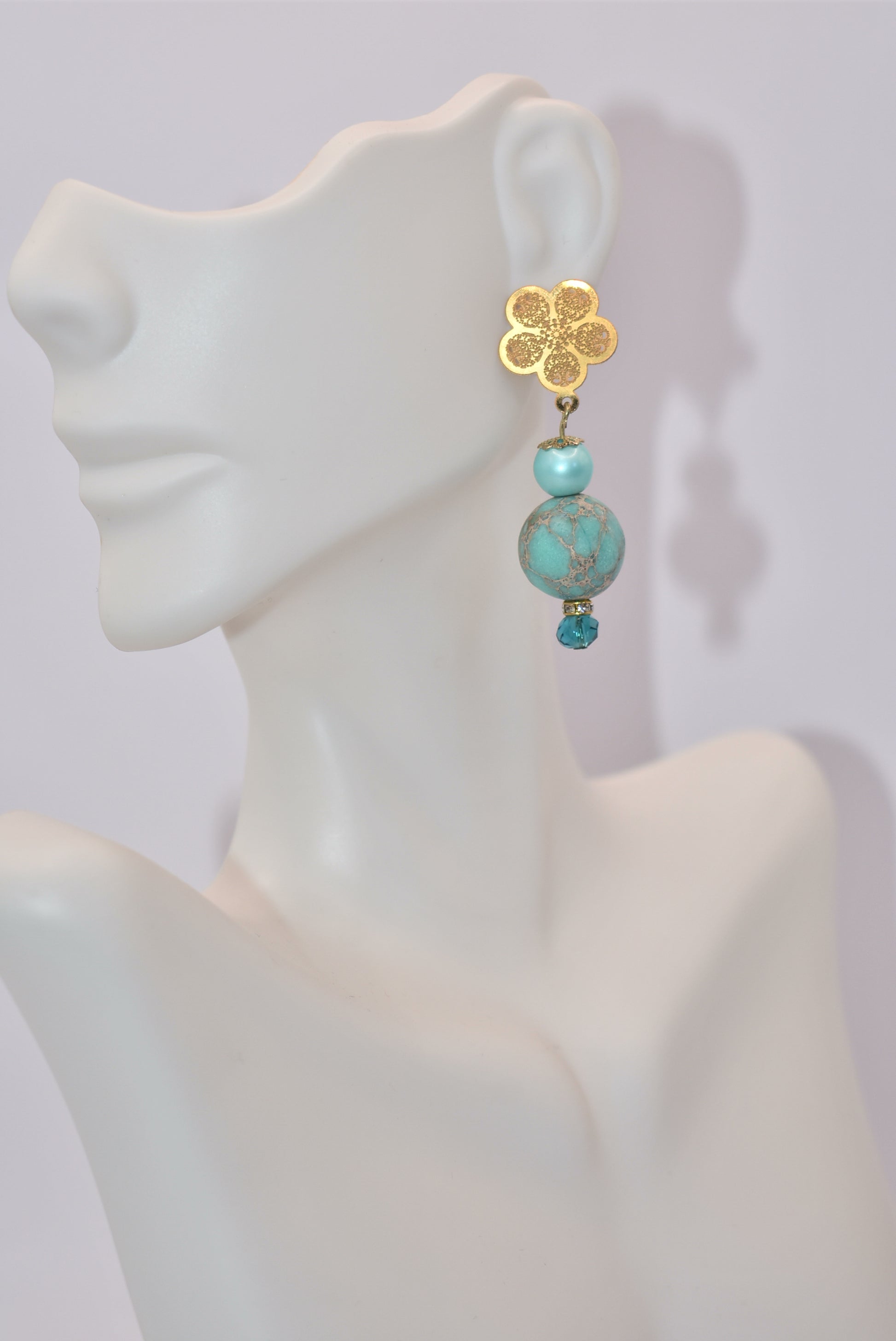 Get ready for adventure? These earrings are ready to go with you.&nbsp; Gold flowered hanging post earrings with aqua pearls, pretty beads and diamond crystal accents bring these beauties together. Nickel free and hypoallergenic for sensitive ears.&nbsp; Super comfortable on the ear.&nbsp; One-of-a-kind-piece.