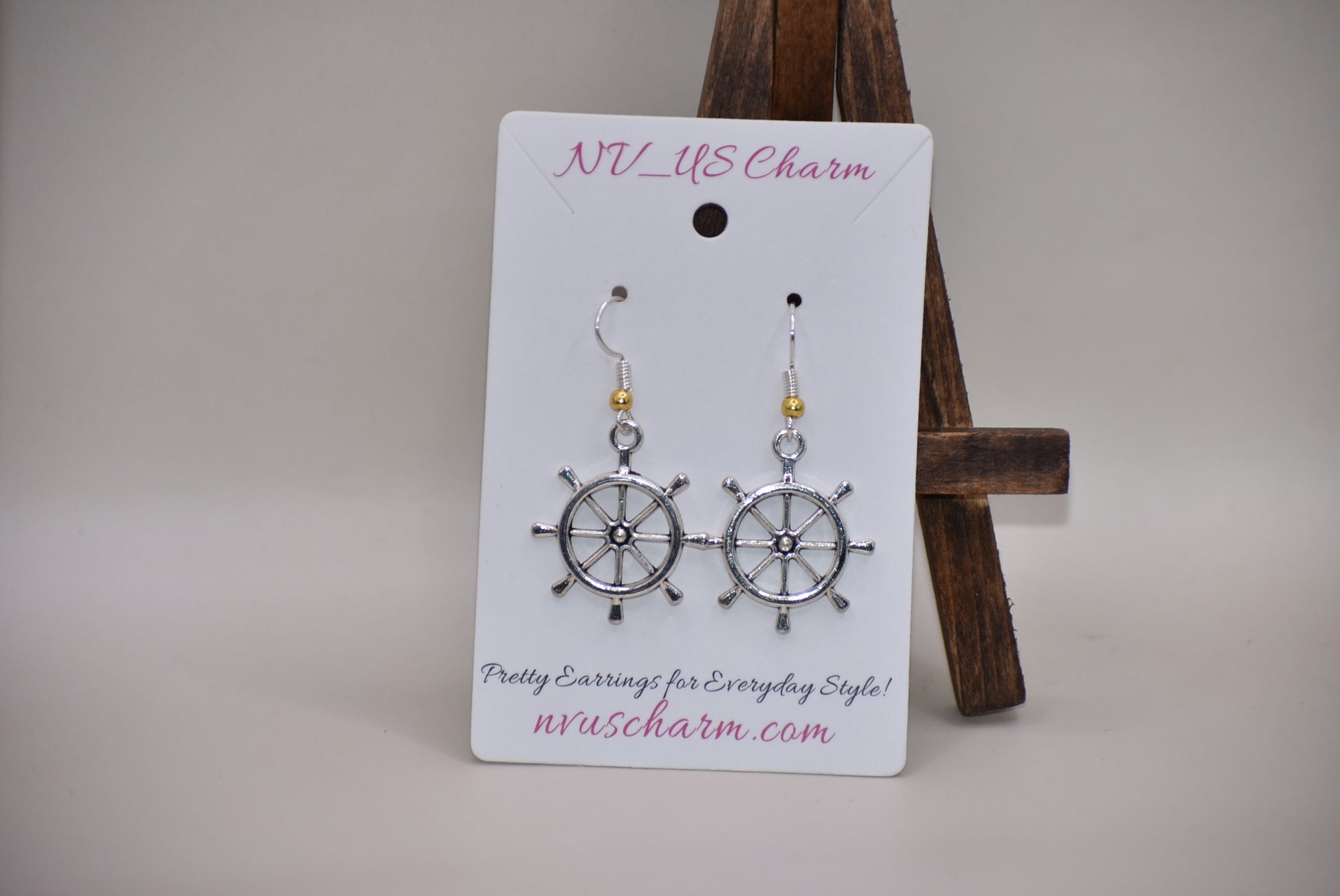 "Add some nautical charm to your look with these adorable wheel earrings ⚓ Made with hypoallergenic silver hooks and a stylish gold ball, these earrings are perfect for any outfit. Look cute and feel comfortable with the Nautical Collection!"