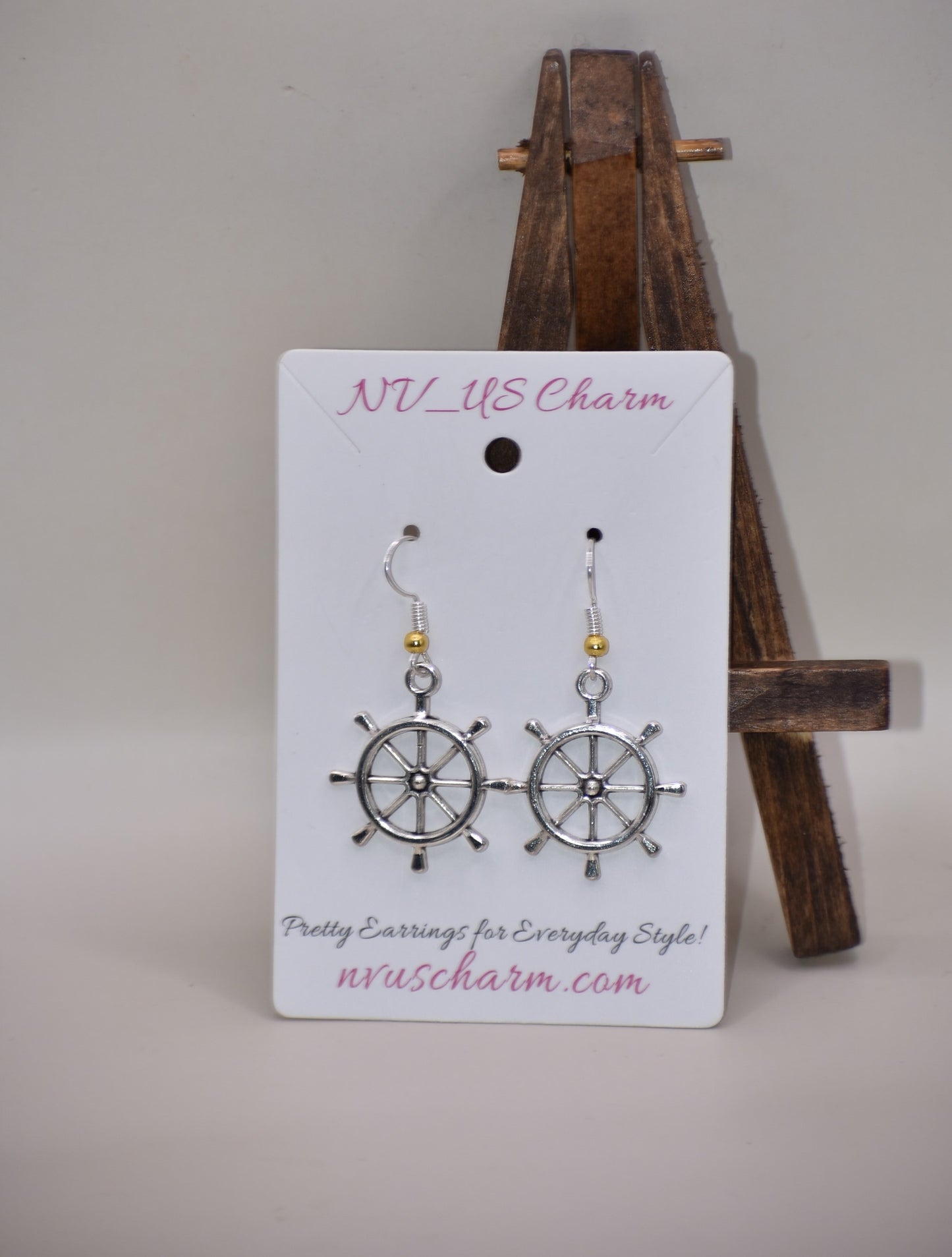 "Add some nautical charm to your look with these adorable wheel earrings ⚓ Made with hypoallergenic silver hooks and a stylish gold ball, these earrings are perfect for any outfit. Look cute and feel comfortable with the Nautical Collection!"