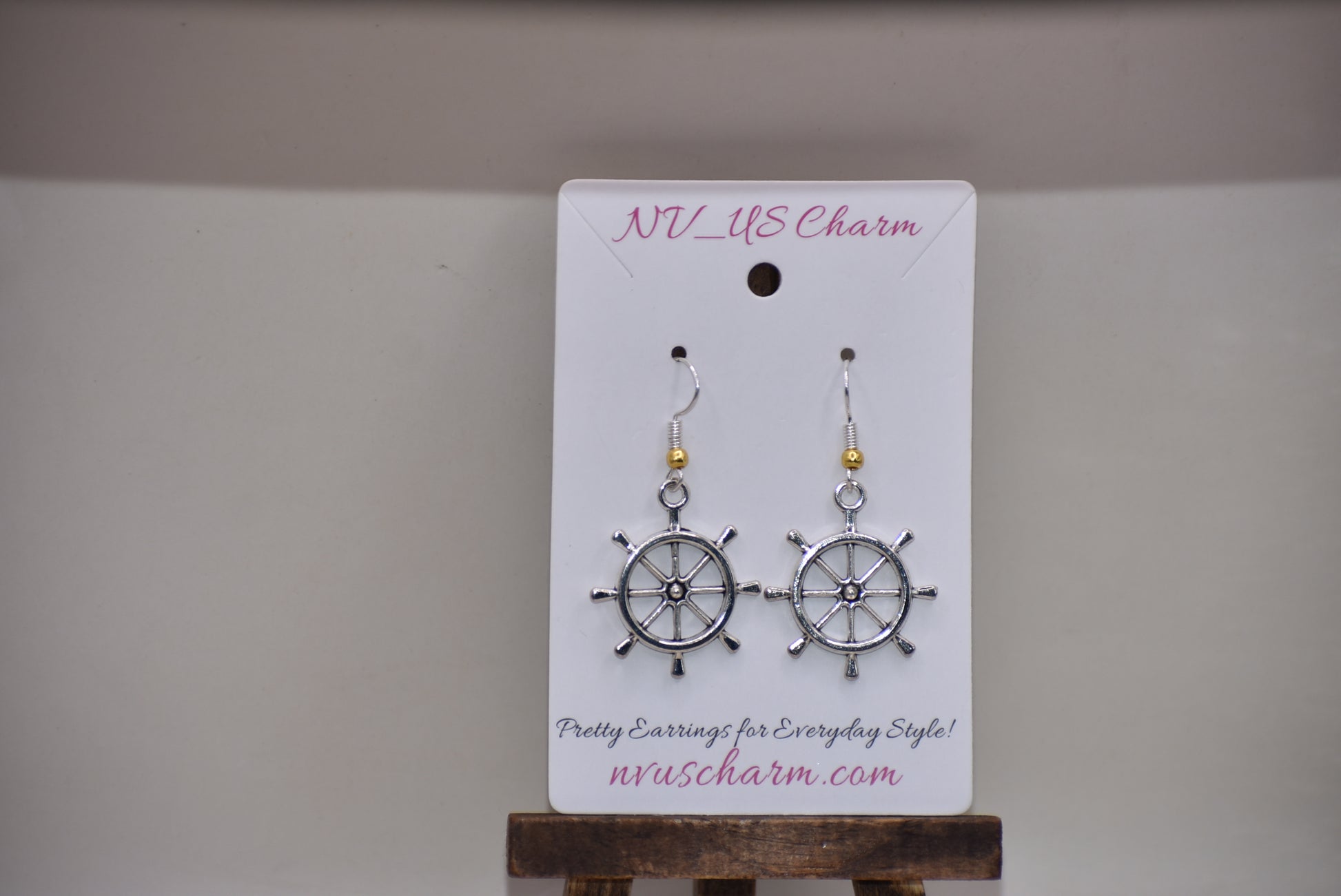 "Add some nautical charm to your look with these adorable wheel earrings ⚓ Made with hypoallergenic silver hooks and a stylish gold ball, these earrings are perfect for any outfit. Look cute and feel comfortable with the Nautical Collection!"