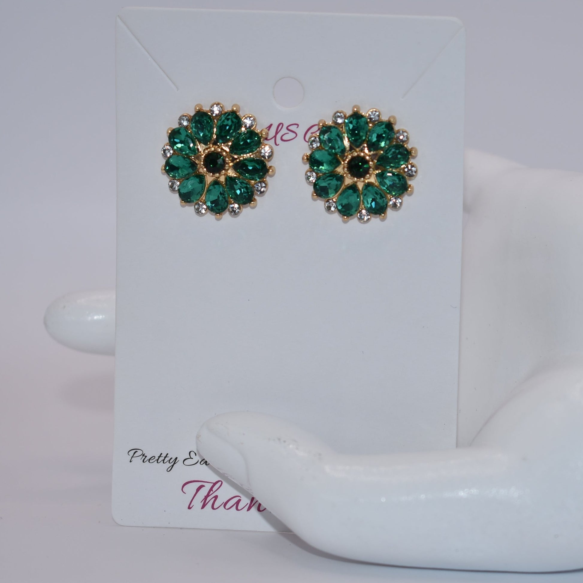 Unleash your unique style with our Green Collection earrings! These eye-catching post earrings feature hypoallergenic posts and stunning emerald green and white crystals. With a vintage-inspired design, you're sure to turn heads and make a statement. Perfect for any special occasion outfit!