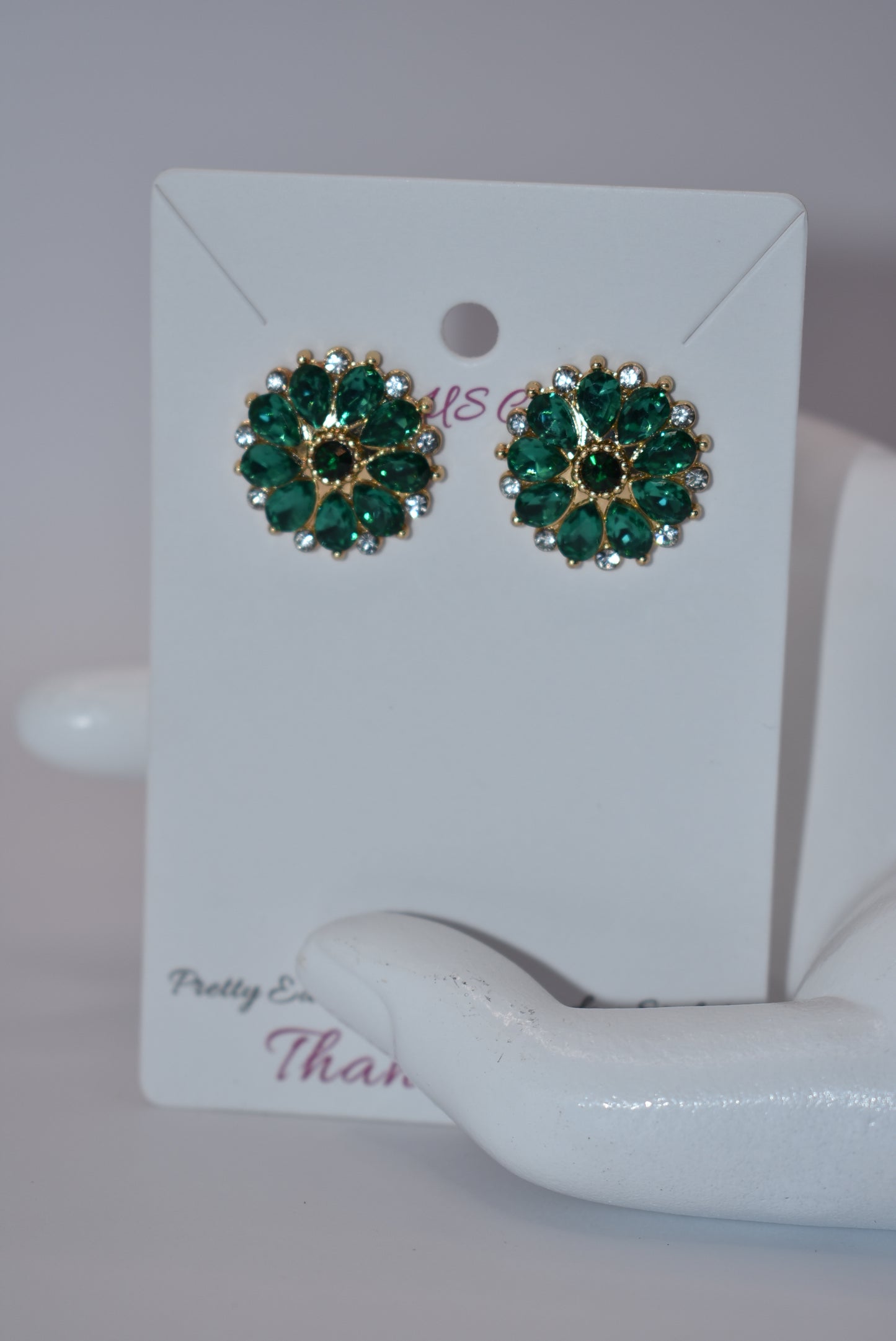 Unleash your unique style with our Green Collection earrings! These eye-catching post earrings feature hypoallergenic posts and stunning emerald green and white crystals. With a vintage-inspired design, you're sure to turn heads and make a statement. Perfect for any special occasion outfit!