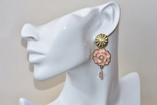 This classic Pink Collection 27 statement earring is perfect for any occasion! Its one-of-a-kind design features a pink flower with a crystal center and pink crystal accents, all balanced atop bold gold posts. Perfect for adding an elegant touch to any look.  Slightly on the heavier side 