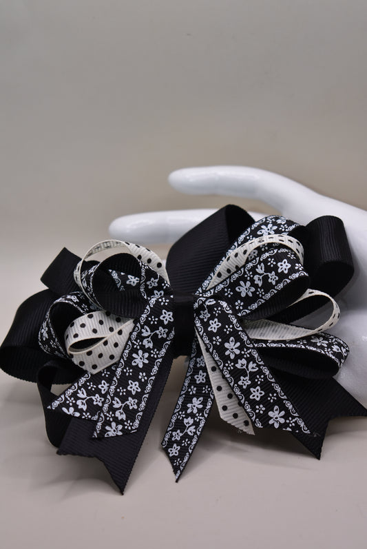 Unleash your little girl's style with Nana's Collection 76! This elegant bow is a perfect combination of black and cream, topped off with a pretty multi-mixed ribbon. The wrapped alligator clip adds ease of wear, making it ideal for any outfit. You'll love how this bow brings your little one's look to life. 🎀