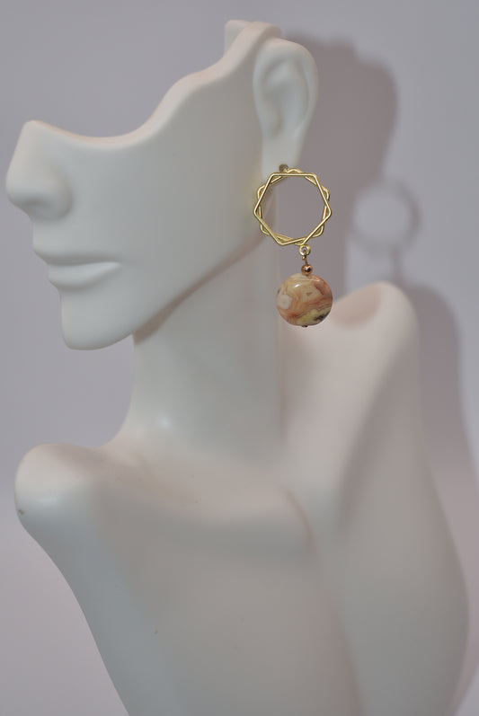 Be unique with Gold Collection 3! This one-of-a-kind piece features hypoallergenic posts with a stylish and comfortable open circle design. The beautiful neutral round stone will elevate any outfit. Perfect for any occasion, it's the perfect accessory for whatever you're wearing. (And it won't irritate your ears!)