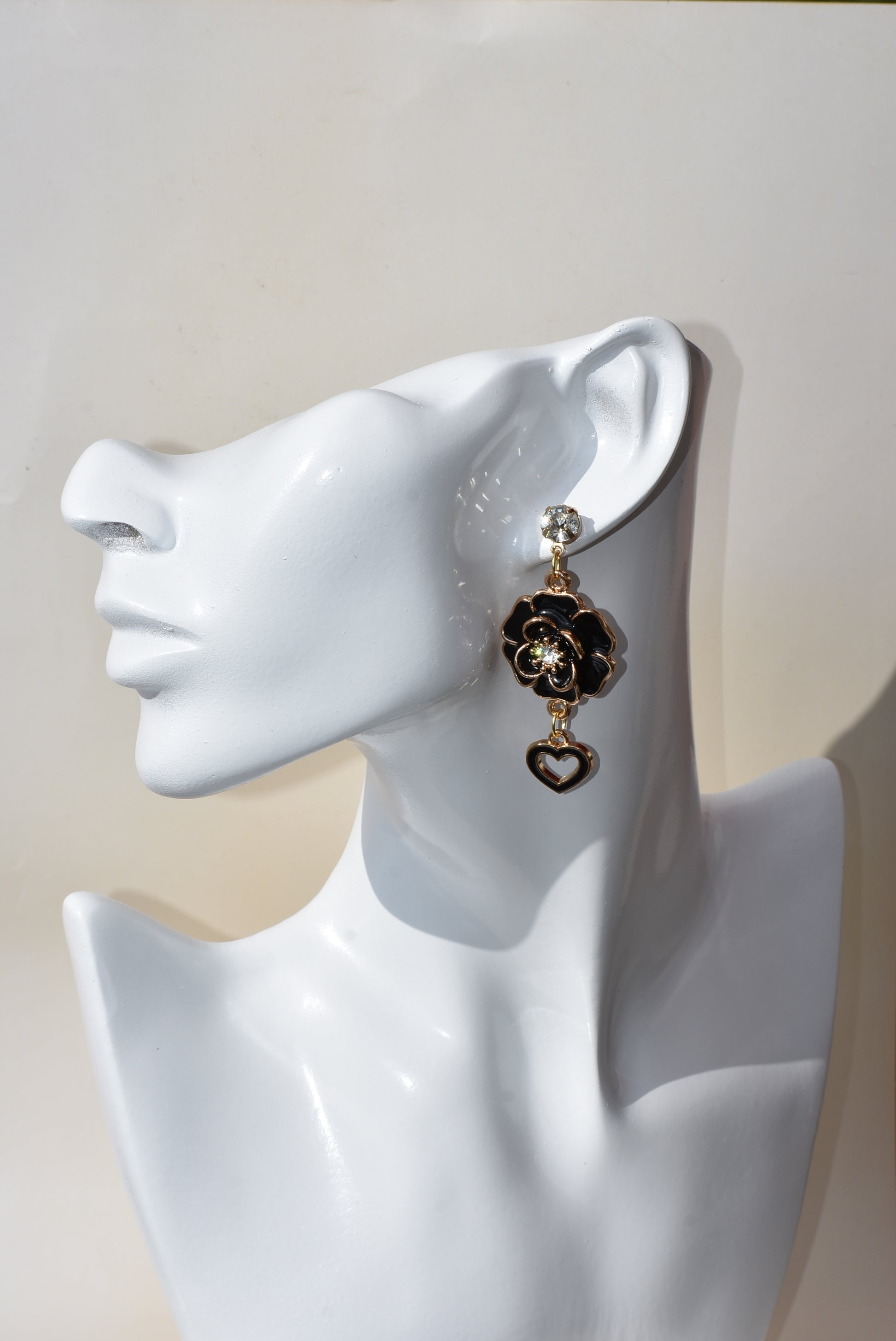 These black beauties are diamond posts with black flowers with middle crystal and have a hanging black open heart on the bottom.  They are on the heavier side. Gorgeous on the ear.  One-of-a-kind piece.