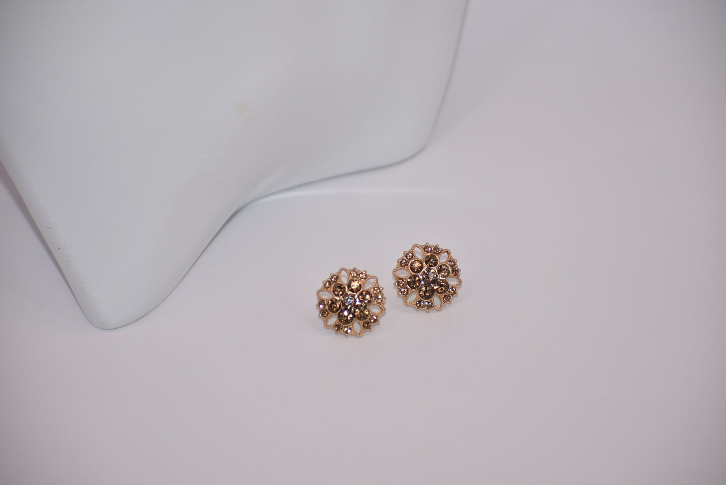 These charming auburn crystal flower earrings add a touch of elegance to your wedding look. The hypoallergenic gold posts provide all-day comfort for sensitive ears. Fall in love with the perfect amount of bling.