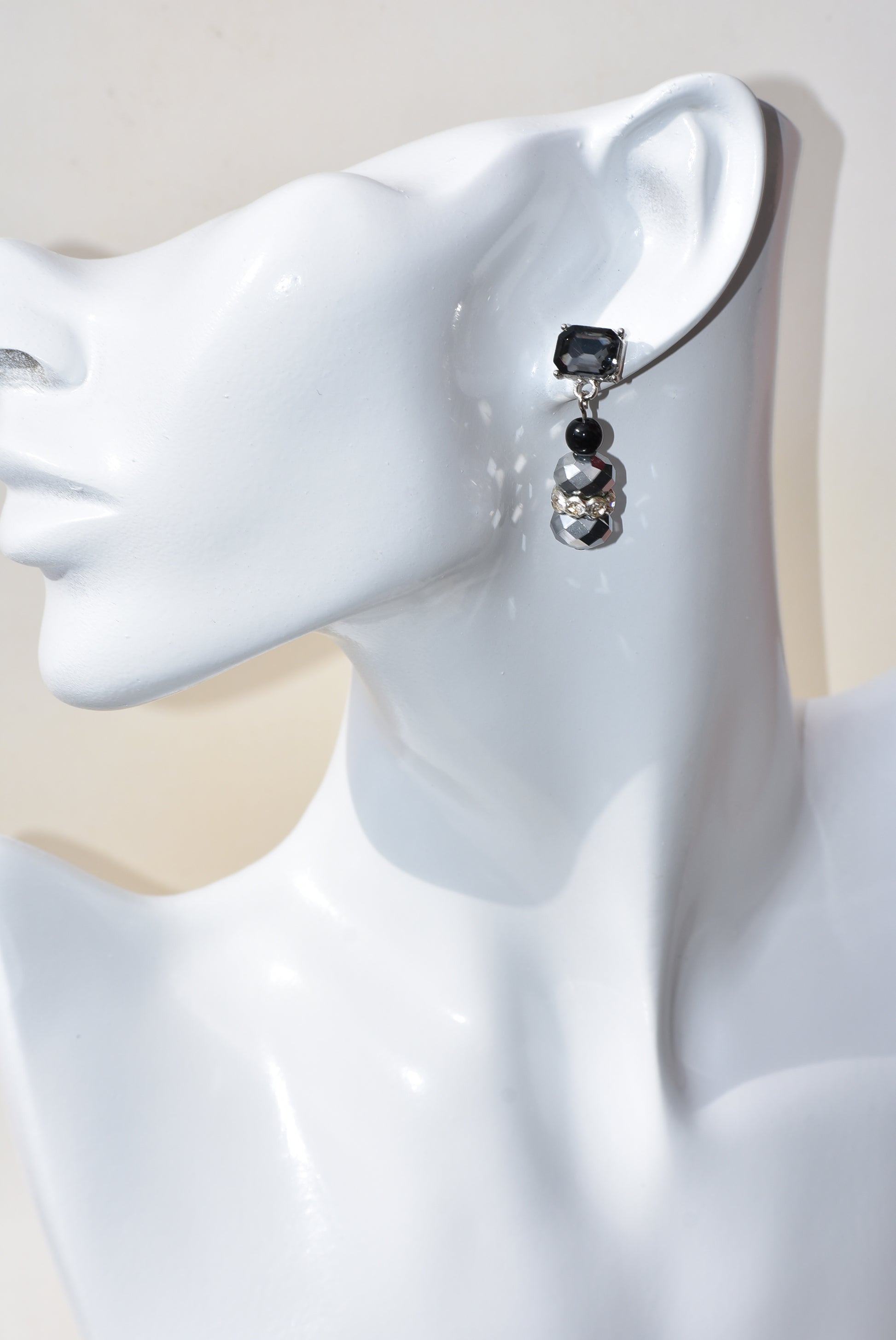 This Black Collection 13 earring set is crafted featuring exquisite black crystal square posts and intricately detailed gray and black beading. This timeless jewelry piece is designed to last, perfect for formal occasions or everyday wear.