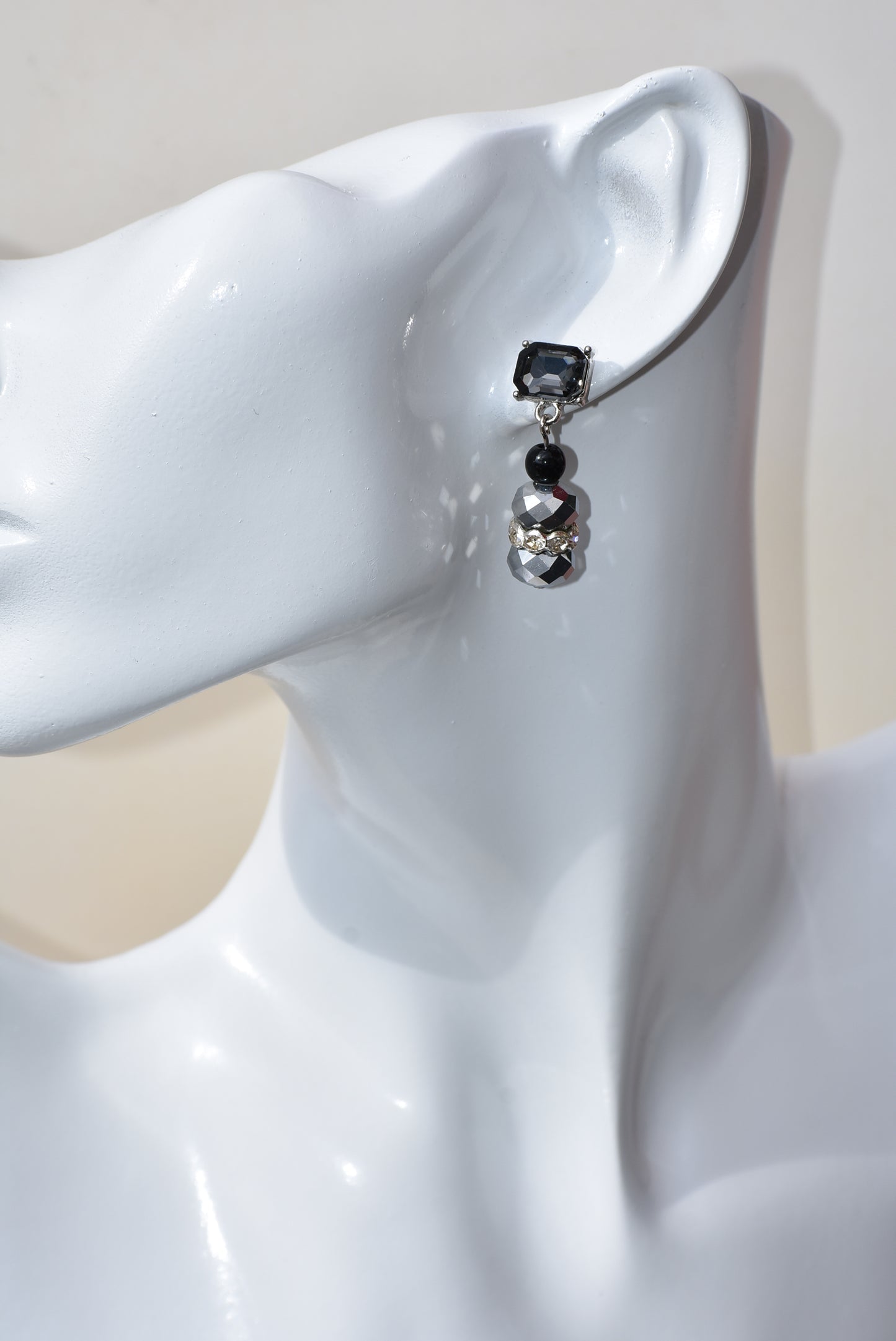 This Black Collection 13 earring set is crafted featuring exquisite black crystal square posts and intricately detailed gray and black beading. This timeless jewelry piece is designed to last, perfect for formal occasions or everyday wear.