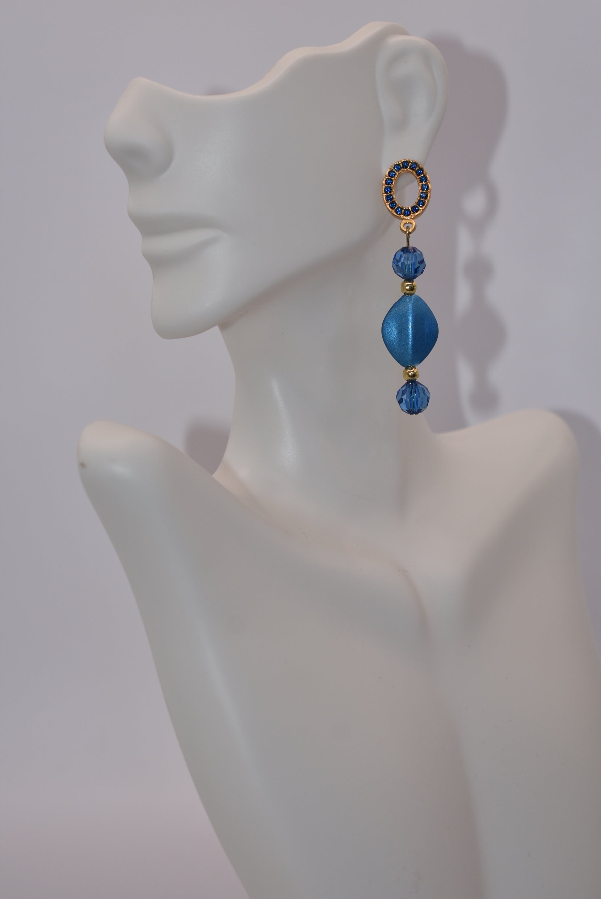 Get ready to dazzle with the Blue Collection 20 earrings! These unique gold and blue crystal oval posts are adorned with stunning shades of blue crystals and beads, making them the perfect accessory for a special evening out. And for those with sensitive ears, fear not - these earrings are hypoallergenic for comfortable wear all night long.