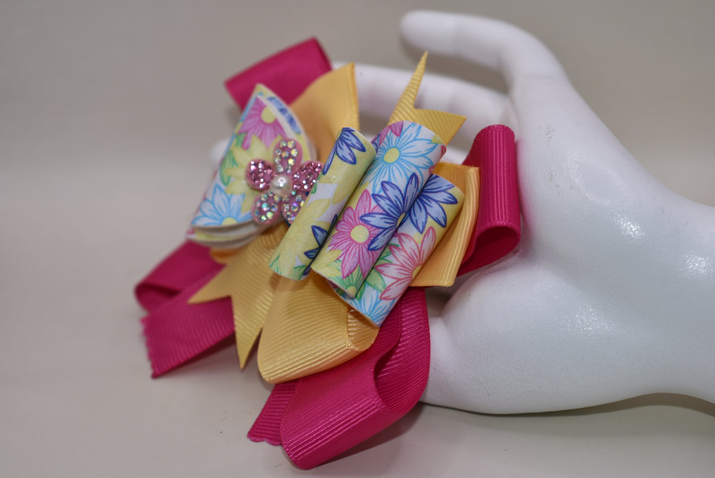 Nana's Collection 83 - Adorable faux leather flowered pattern with a colorful bow and sparkly flower to add the perfect touch to your little cutie's outfit. Includes a wrapped alligator clip for all day secure wear. #FlowerPower 🌸