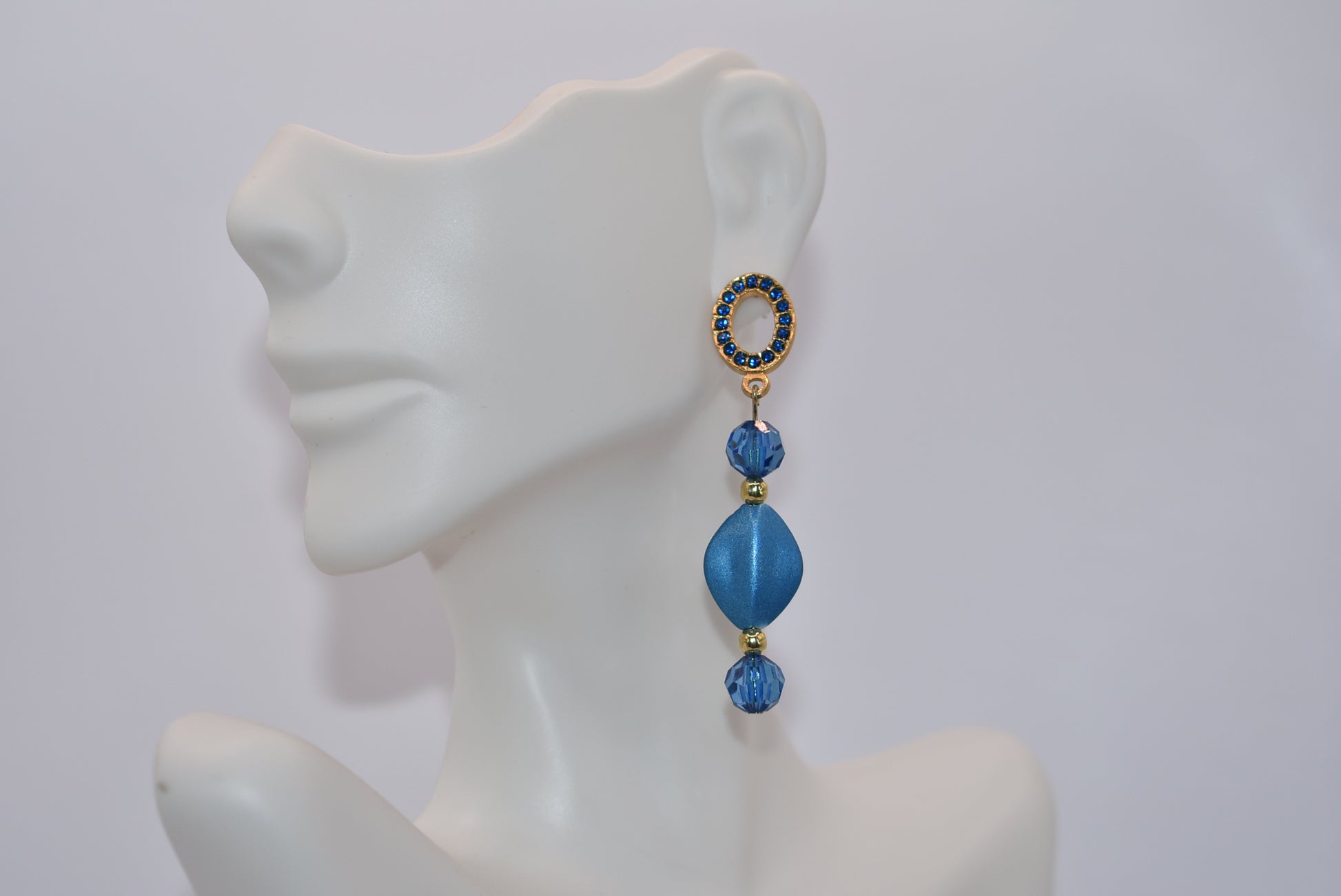 Get ready to dazzle with the Blue Collection 20 earrings! These unique gold and blue crystal oval posts are adorned with stunning shades of blue crystals and beads, making them the perfect accessory for a special evening out. And for those with sensitive ears, fear not - these earrings are hypoallergenic for comfortable wear all night long.